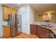 Kitchen features stainless steel appliances, granite countertops, and warm cabinetry at 7321 Harrisonwoods Pl, Charlotte, NC 28270