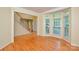 Bright living room with hardwood floors, large windows, and views of the staircase and entry at 7321 Harrisonwoods Pl, Charlotte, NC 28270