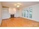Bright living room boasts a fireplace with built-ins and large windows for plenty of natural light at 7321 Harrisonwoods Pl, Charlotte, NC 28270