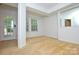 A cozy living area with a door to the outside, a large window, and neutral carpeting at 7321 Harrisonwoods Pl, Charlotte, NC 28270