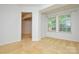 This bright living room boasts neutral carpeting, a large window, and easy access to other rooms at 7321 Harrisonwoods Pl, Charlotte, NC 28270