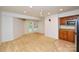 Spacious living room with a kitchenette, carpeted floors, and a walkout to the yard at 7321 Harrisonwoods Pl, Charlotte, NC 28270