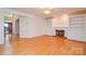 Bright living room features a fireplace, built-in shelving, and hardwood floors at 7321 Harrisonwoods Pl, Charlotte, NC 28270
