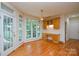 Cozy sunroom with access to the outdoor space features a ceiling fan and lots of natural light at 7321 Harrisonwoods Pl, Charlotte, NC 28270
