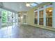Enclosed sunroom with tile floor, ceiling fan, and plenty of windows for natural light at 7321 Harrisonwoods Pl, Charlotte, NC 28270