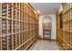 Spacious wine cellar with custom wooden wine racks and a decorative wall mural above a table at 7321 Harrisonwoods Pl, Charlotte, NC 28270