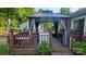 A deck with a gazebo, outdoor seating, and lovely greenery to create an inviting entertainment space at 7401 Merrily Ln, Charlotte, NC 28214