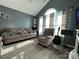 A well-lit living room features vaulted ceilings, a cozy seating arrangement, and stylish decor at 7401 Merrily Ln, Charlotte, NC 28214