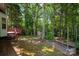 The expansive backyard features a wooden deck, lush greenery, and a storage shed at 8002 Kingston Dr, Waxhaw, NC 28173