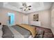 Bedroom featuring a tray ceiling, carpeted floors, a ceiling fan, and bright paint at 8002 Kingston Dr, Waxhaw, NC 28173