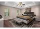 Bedroom featuring a tray ceiling, carpeted floors, and a modern bed at 8002 Kingston Dr, Waxhaw, NC 28173