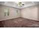 Large bedroom featuring neutral tones, ceiling fan and natural light from multiple windows at 8002 Kingston Dr, Waxhaw, NC 28173