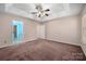 Spacious bedroom features neutral tones, ceiling fan, and natural light from windows at 8002 Kingston Dr, Waxhaw, NC 28173