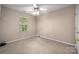 A well lit bedroom featuring neutral walls, carpeted floors and a window at 8002 Kingston Dr, Waxhaw, NC 28173