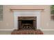 Close up on fireplace with brick hearth, white mantle, and glass screen at 8002 Kingston Dr, Waxhaw, NC 28173