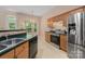 Bright kitchen featuring stainless steel appliances, wooden cabinets, and a sunlit breakfast nook at 8002 Kingston Dr, Waxhaw, NC 28173