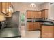 Kitchen featuring stainless steel refrigerator, wooden cabinets, and adjacent breakfast area at 8002 Kingston Dr, Waxhaw, NC 28173