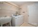 Functional laundry room area complete with sink, washer, and dryer at 8002 Kingston Dr, Waxhaw, NC 28173