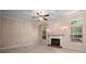 Living room with fireplace, ceiling fan, and ample natural light from multiple windows at 8002 Kingston Dr, Waxhaw, NC 28173