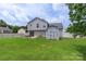 The backyard features a lush lawn, a tool shed and mature trees, for outdoor entertaining at 8904 Gerald Dr, Charlotte, NC 28217