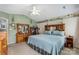 Bright bedroom boasts a queen-sized bed, wood furnishings, and natural light at 8904 Gerald Dr, Charlotte, NC 28217