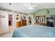 Spacious primary bedroom features an attached bath, work space, and charming decor at 8904 Gerald Dr, Charlotte, NC 28217