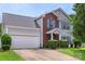 Charming two-story home with a brick facade, light grey siding, blue shutters, and a well-maintained front yard at 8904 Gerald Dr, Charlotte, NC 28217