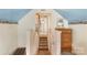 Upstairs hallway with a stairway down, wood dresser, and ocean-themed wallpaper at 8904 Gerald Dr, Charlotte, NC 28217