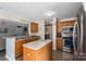 Open kitchen with wood cabinets, stainless steel appliances, and center island at 8904 Gerald Dr, Charlotte, NC 28217