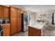 Kitchen with ample wood cabinets, stainless steel refrigerator, and center island at 8904 Gerald Dr, Charlotte, NC 28217