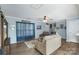 Comfortable living room with soft couches, a ceiling fan, and wood-look flooring at 8904 Gerald Dr, Charlotte, NC 28217