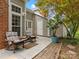 Outdoor patio with two chairs, a brick chimney, and lush greenery, perfect for relaxation and entertaining at 9473 Kings Falls Dr, Charlotte, NC 28210