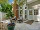 Outdoor patio with two chairs, a brick chimney, and lush greenery, perfect for relaxation and entertaining at 9473 Kings Falls Dr, Charlotte, NC 28210