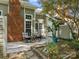 Charming backyard patio with seating, lush greenery, and a brick chimney creating an inviting outdoor space at 9473 Kings Falls Dr, Charlotte, NC 28210