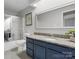 Bathroom with a vanity, granite countertops, a large mirror, and a shower with glass doors at 9473 Kings Falls Dr, Charlotte, NC 28210