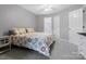 Cozy bedroom with floral bedding, a ceiling fan, and neutral gray paint, creating a relaxing atmosphere at 9473 Kings Falls Dr, Charlotte, NC 28210