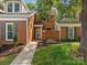 Close up of a lovely red brick house with inviting walkway to front door at 9473 Kings Falls Dr, Charlotte, NC 28210