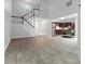 Open-concept living room featuring stairs, modern kitchen, and light wood flooring throughout at 9473 Kings Falls Dr, Charlotte, NC 28210