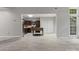 Living room showcasing light wood flooring, modern kitchen and a large window providing lots of natural light at 9473 Kings Falls Dr, Charlotte, NC 28210