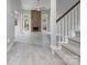 Inviting living room with hardwood floors, a brick fireplace, and abundant natural light from large windows at 9473 Kings Falls Dr, Charlotte, NC 28210