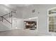 Open-concept living room featuring stairs, modern kitchen, and large windows offering plenty of natural light at 9473 Kings Falls Dr, Charlotte, NC 28210