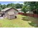 Large, grassy backyard with a storage shed, patio and wood fence at 9716 Psalms St, Cornelius, NC 28031