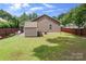 Fenced backyard with storage shed, patio area and green grass at 9716 Psalms St, Cornelius, NC 28031