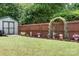 Lovely backyard garden with a storage shed, privacy fence and flower pots at 9716 Psalms St, Cornelius, NC 28031