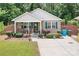Quaint home featuring a welcoming front porch, well-maintained landscaping, and a concrete driveway at 9716 Psalms St, Cornelius, NC 28031