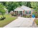 Charming home with lush front yard landscaping and welcoming front porch at 9716 Psalms St, Cornelius, NC 28031