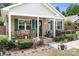 Charming home exterior with rocking chairs on the porch, complemented by lush landscaping at 9716 Psalms St, Cornelius, NC 28031