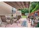 Cozy patio area with brick flooring, dining set, awning, privacy fence and storage shed at 9716 Psalms St, Cornelius, NC 28031