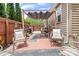 Inviting patio with stylish furniture, awning, privacy fence, and brick flooring perfect for relaxing at 9716 Psalms St, Cornelius, NC 28031