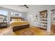Bedroom with hardwood floors, neutral walls, and a rustic wood bed frame at 1011 Westbrook Dr # A, Charlotte, NC 28202